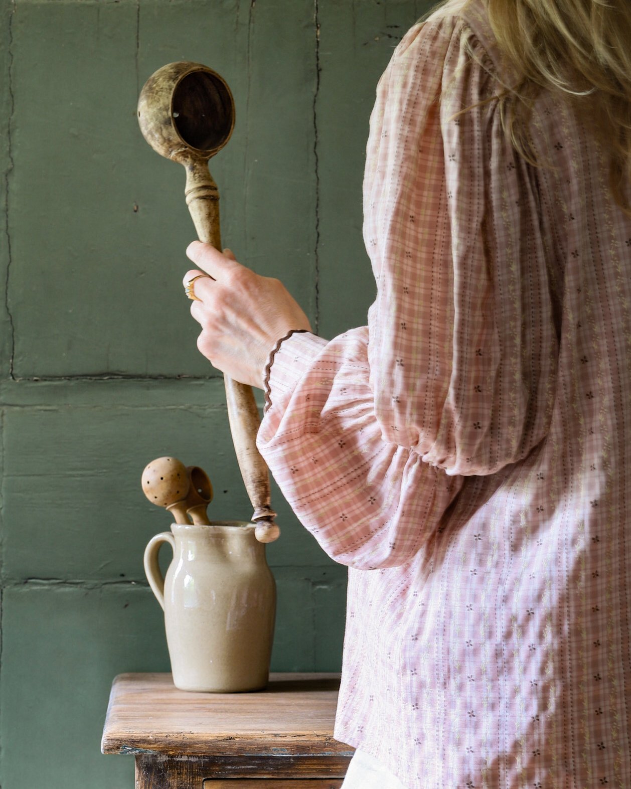 French olive scoop held in hand