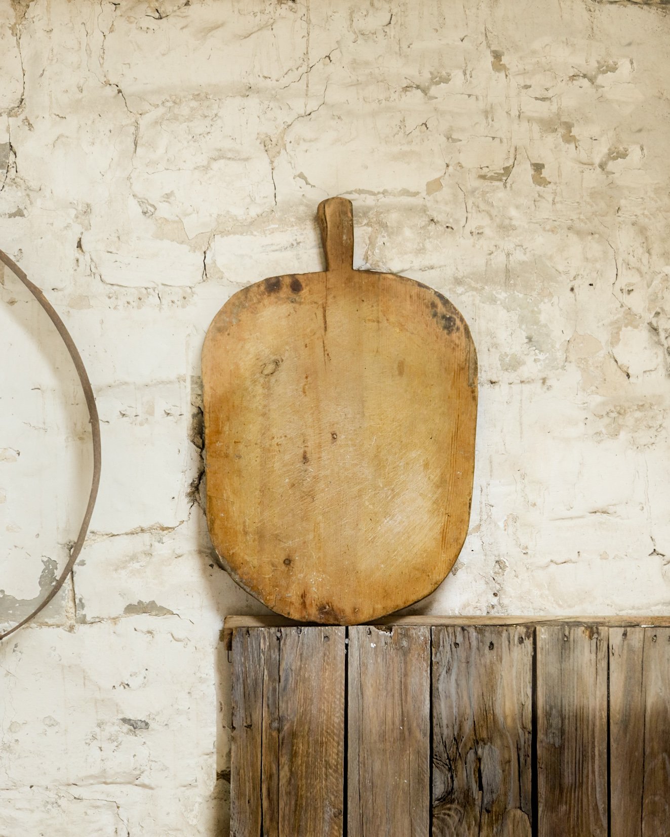 A vintage Turkish breadboard leaning against a wall