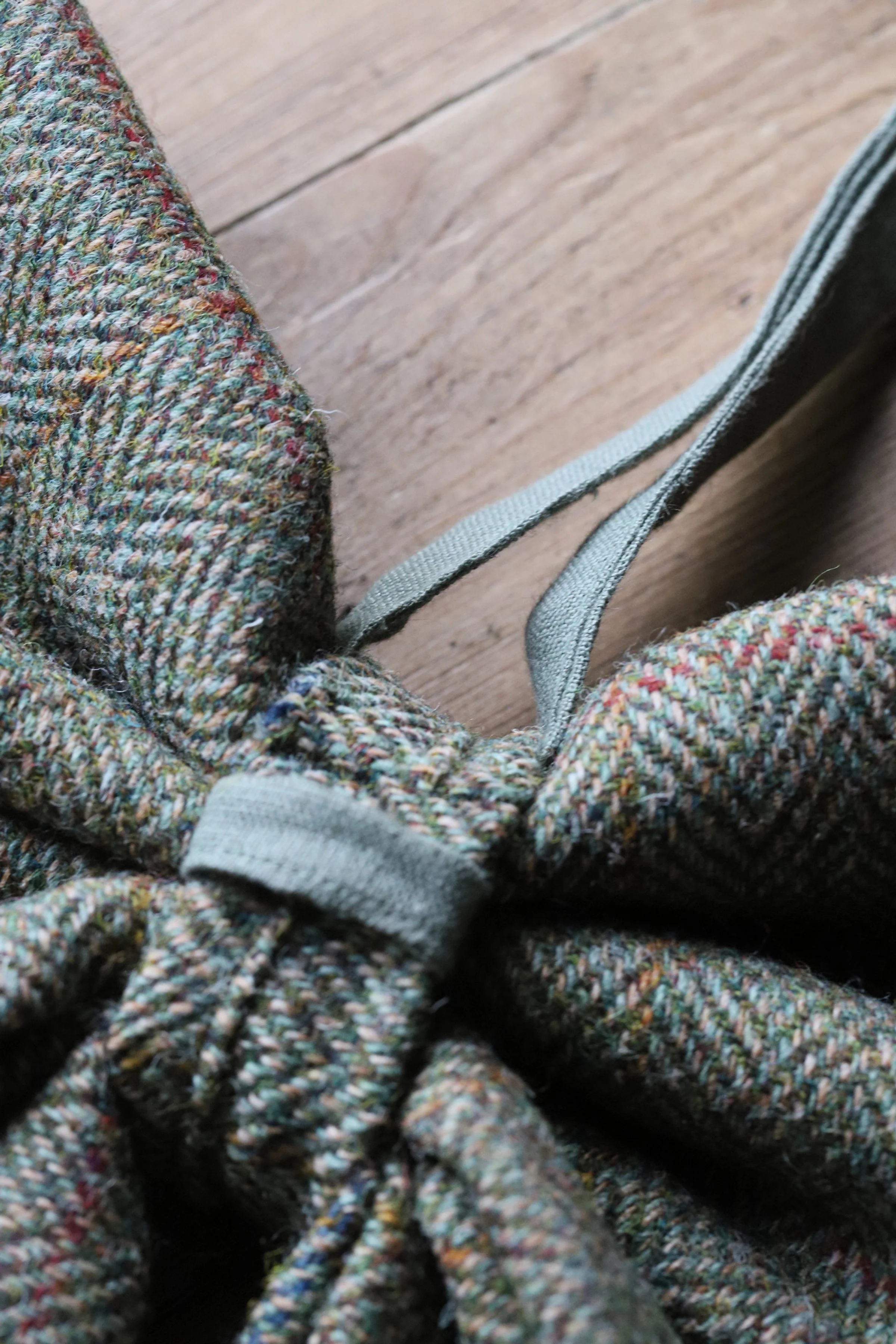 Details of a large hand-sewn tweed wool bow