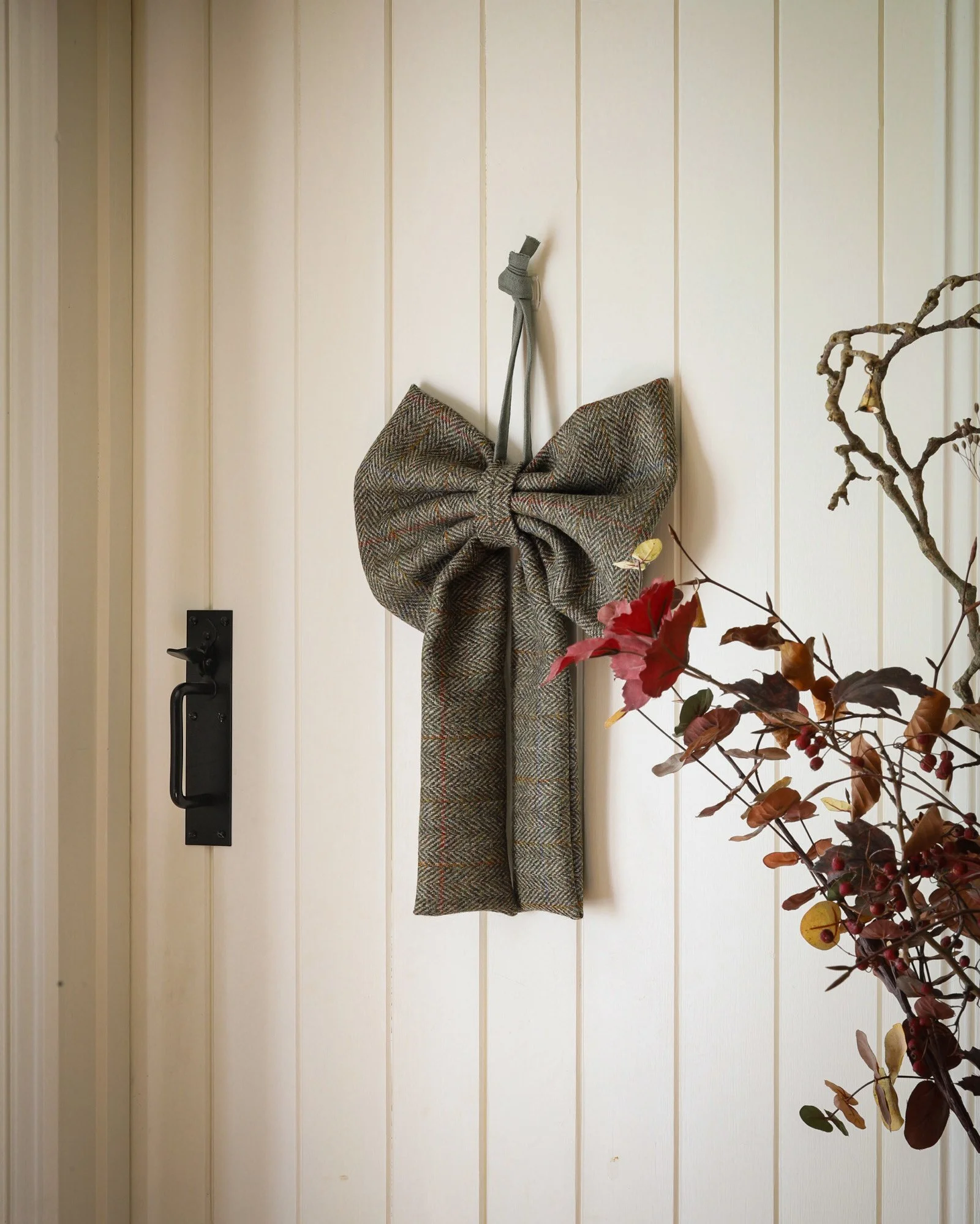 Harris tweed bow hanging on a cottage door