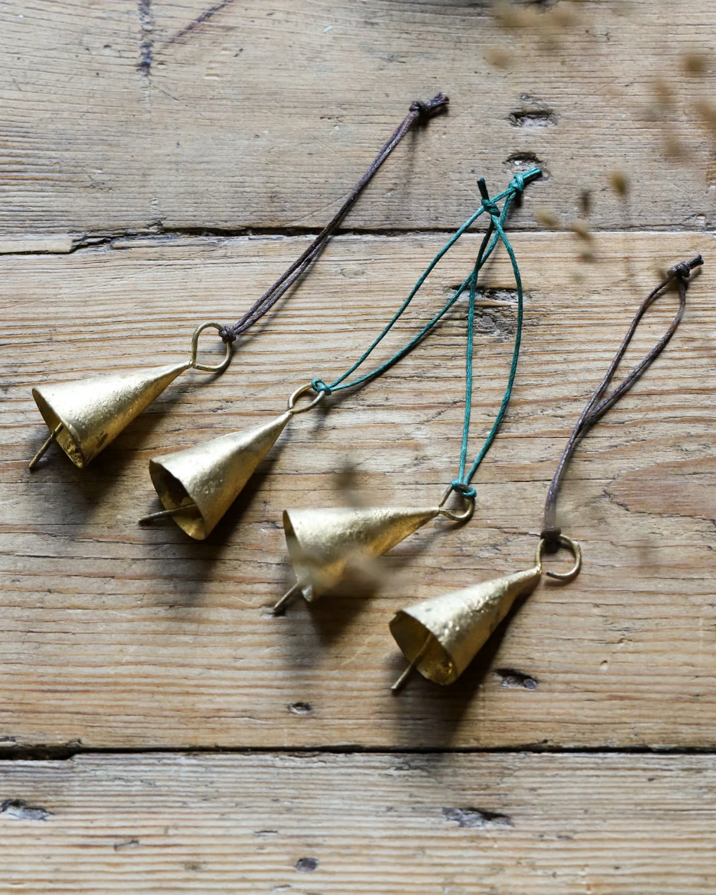 Set of four rustic bells on a vintage table