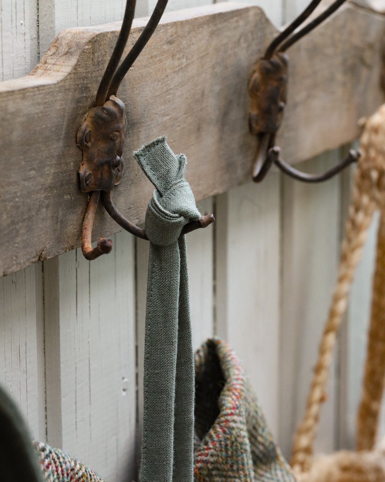 A large tweed bow hanging on a vintage hook