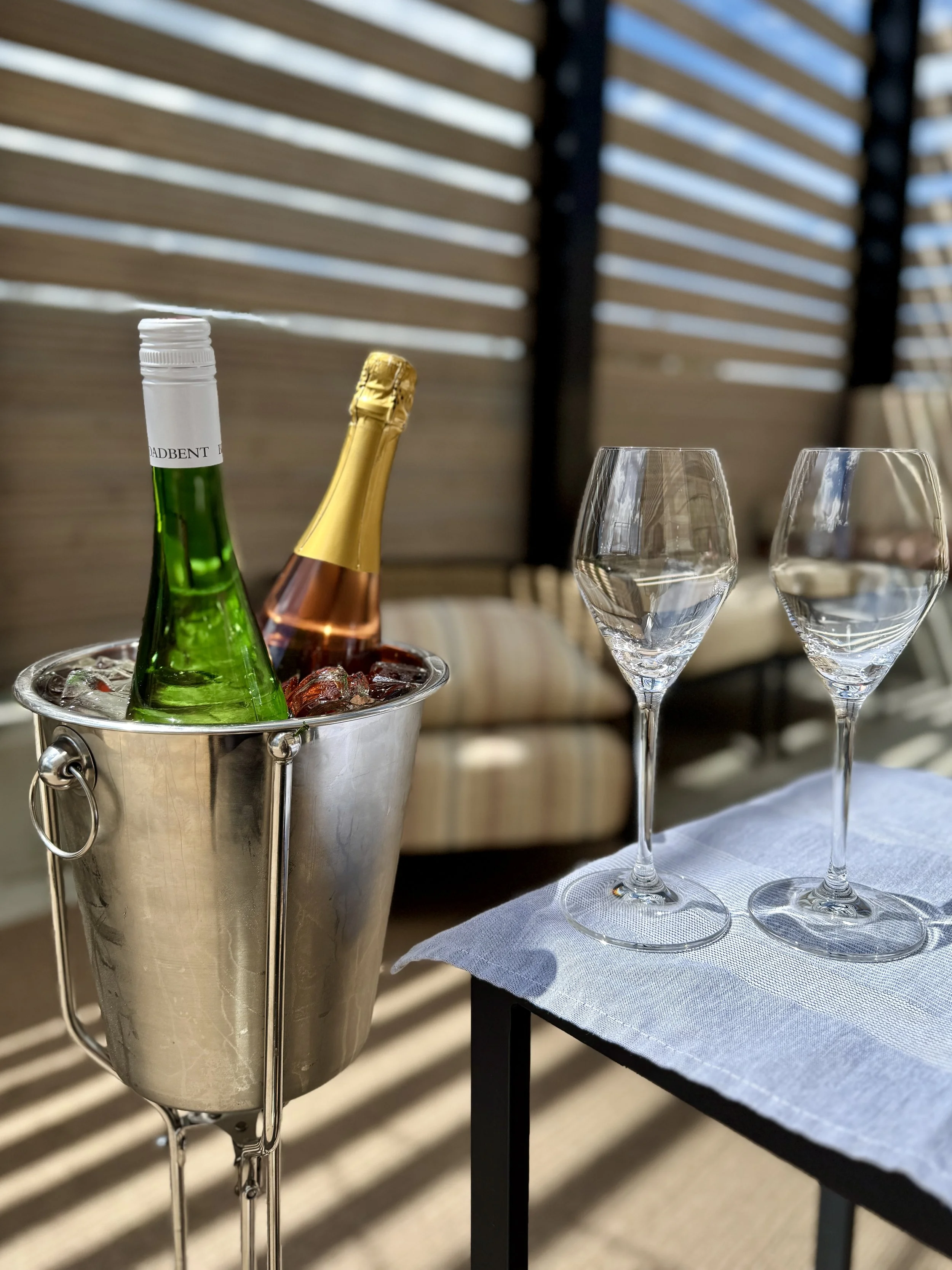 an image of  chilled wine bottles on the patio at Babcock & Miles