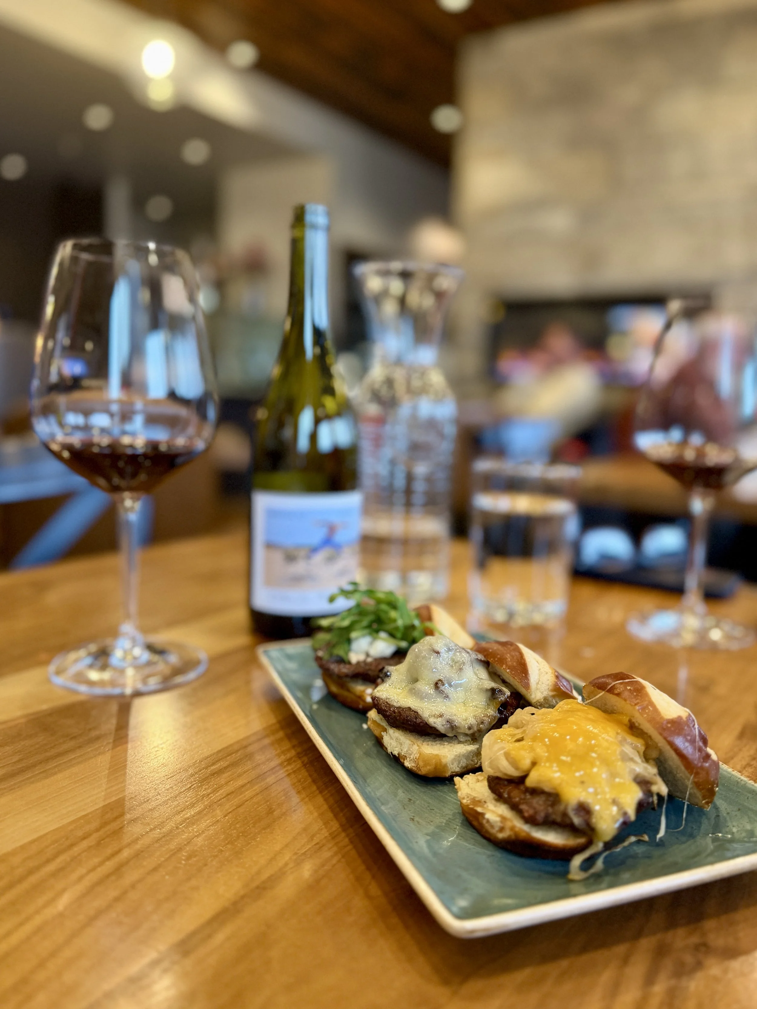 an image of sliders a wine bottle and a glass of wine