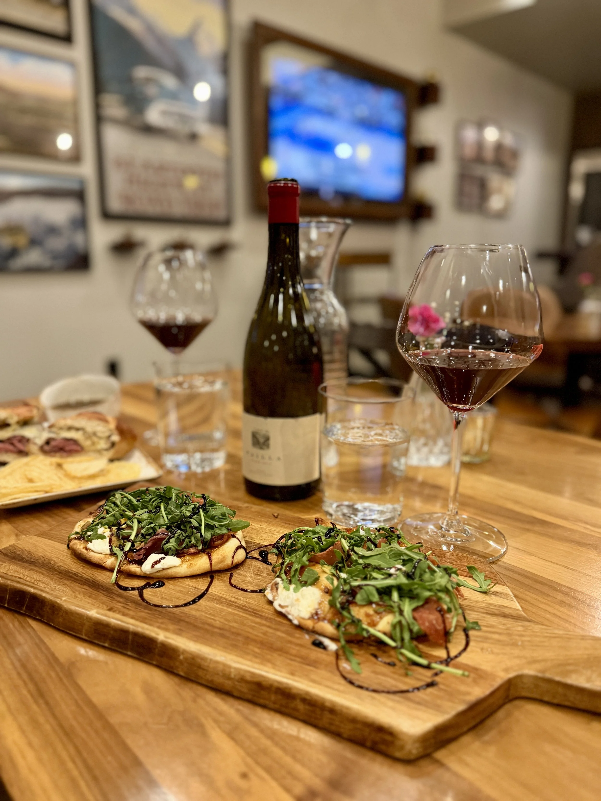 an image of a Babcock & Miles flatbread and wine