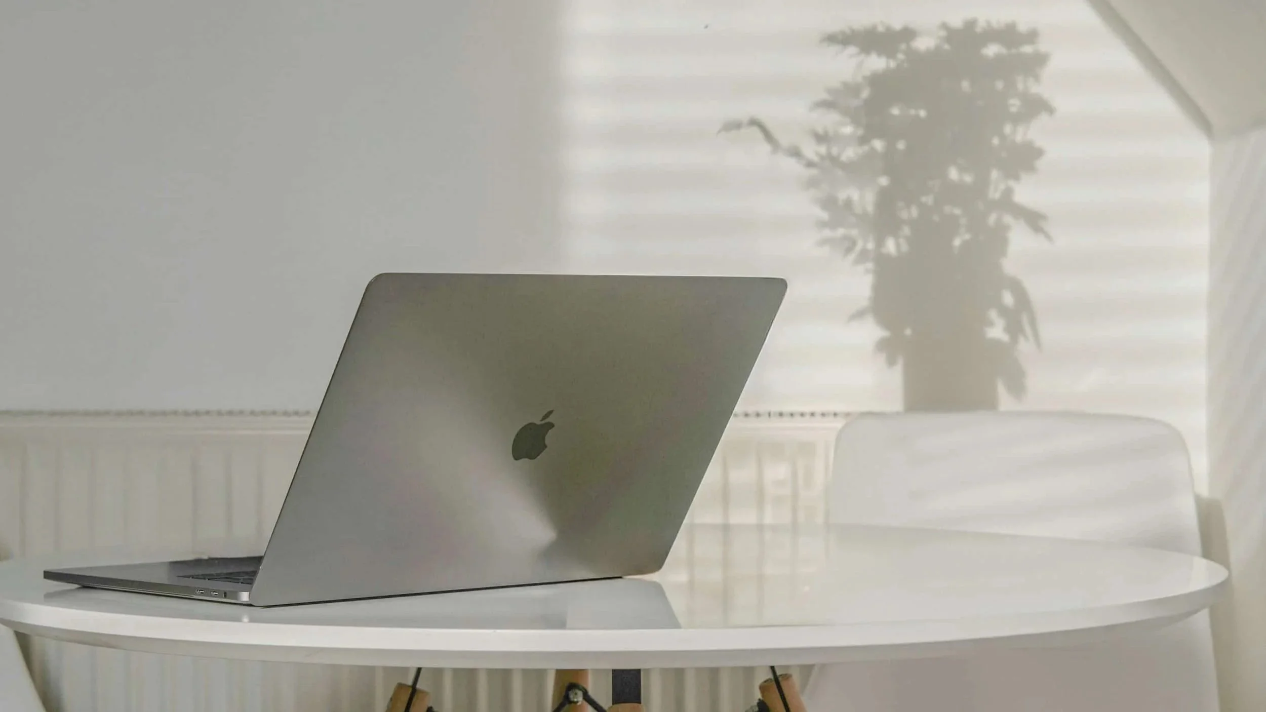 Laptop on a bright workspace table at a Boston graphic design studio