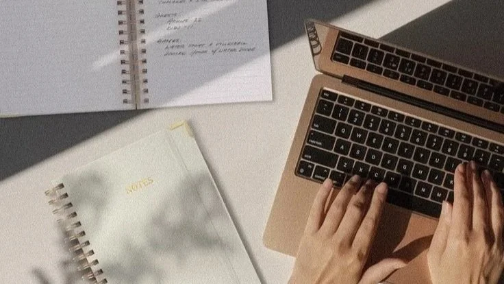 Website design planning with laptop and notebooks for a Boston service business
