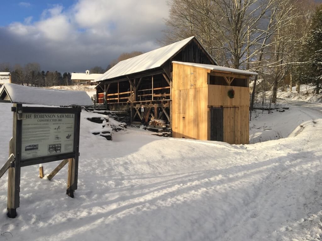 The sawmill and it's sign on a winter day with blue skies.