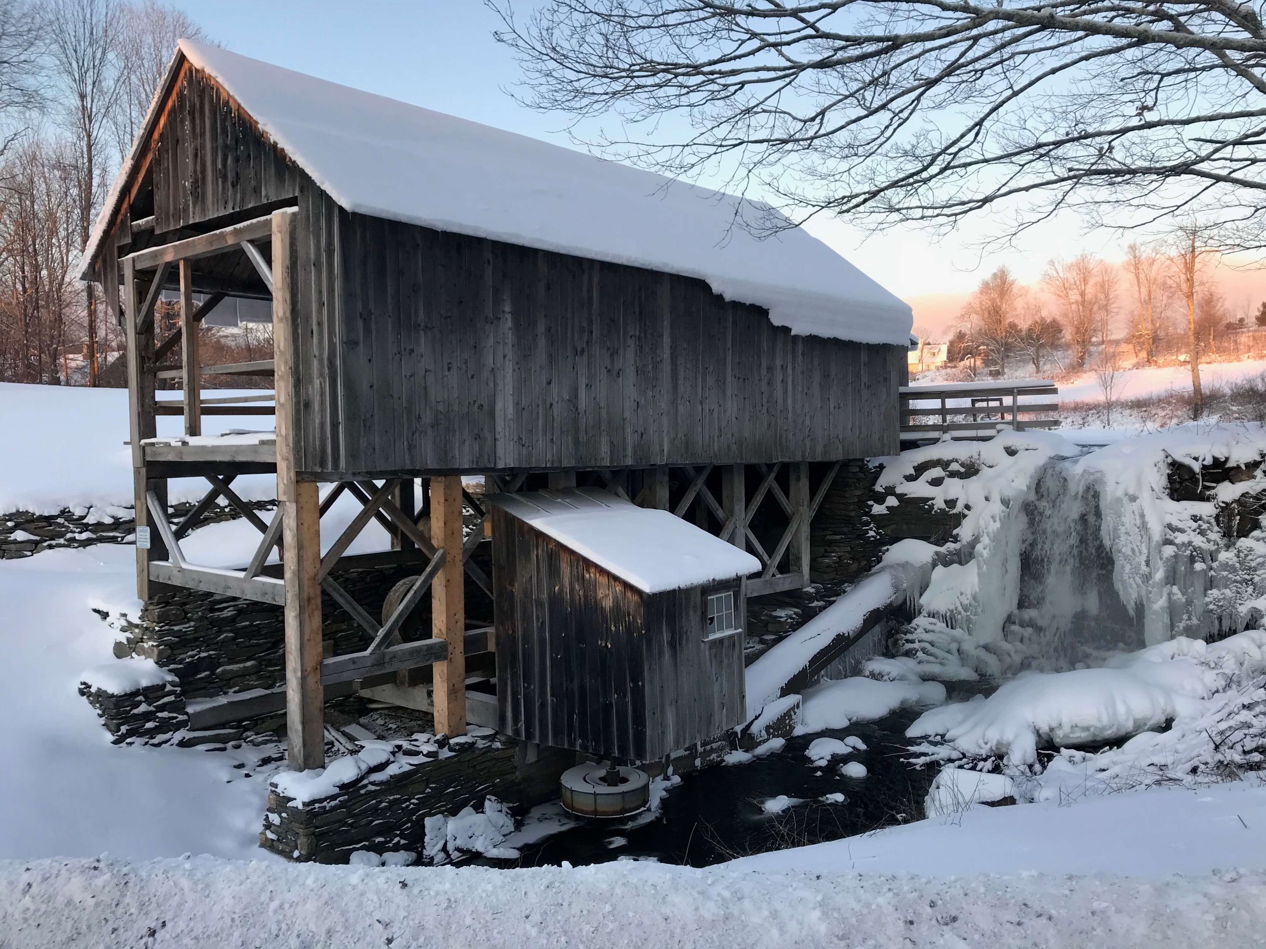 Winter view of the sawmill with frozen waterfall.