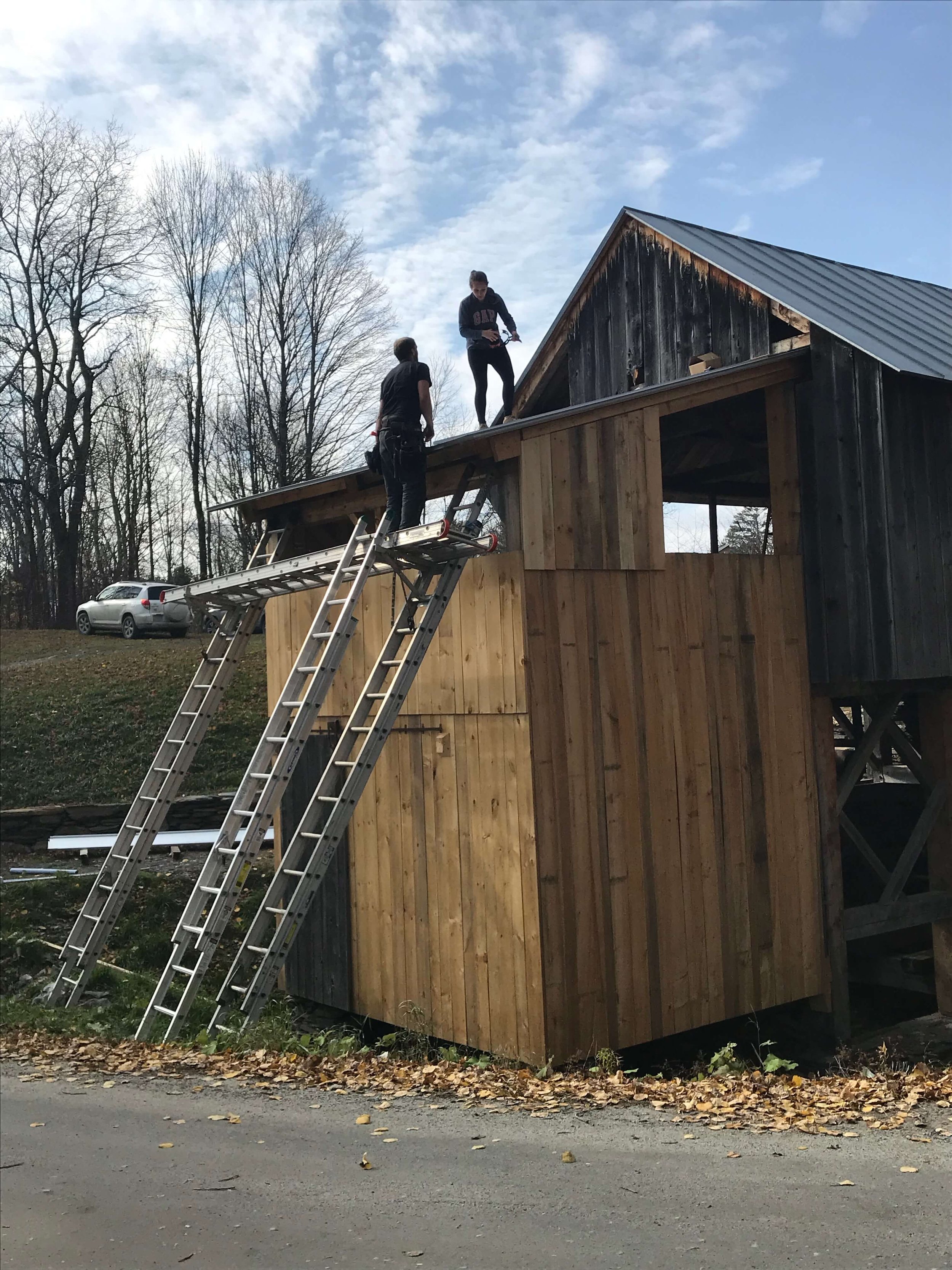 Two people working on the sawmill renovation.