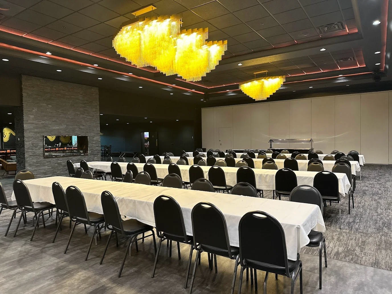 Banquet tables set for an evening dinner event at Stadium View Event Halls with customizable room layouts.