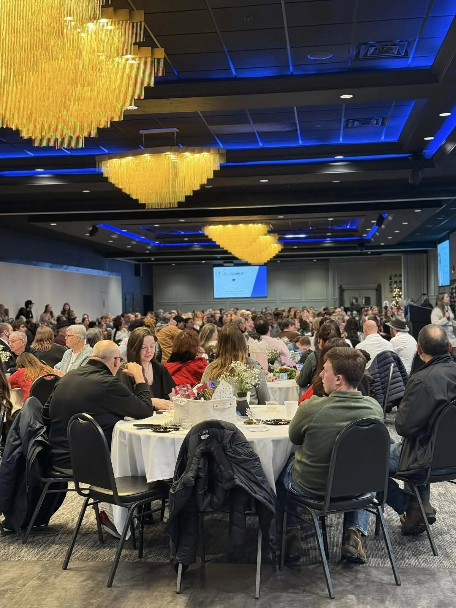 Graduates and guests gathered for a graduation ceremony in a spacious Green Bay banquet hall.