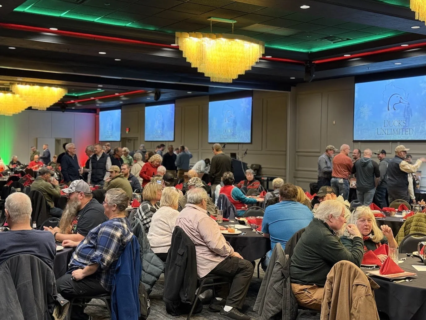 Guests enjoying food and drinks at a Green Bay holiday party venue