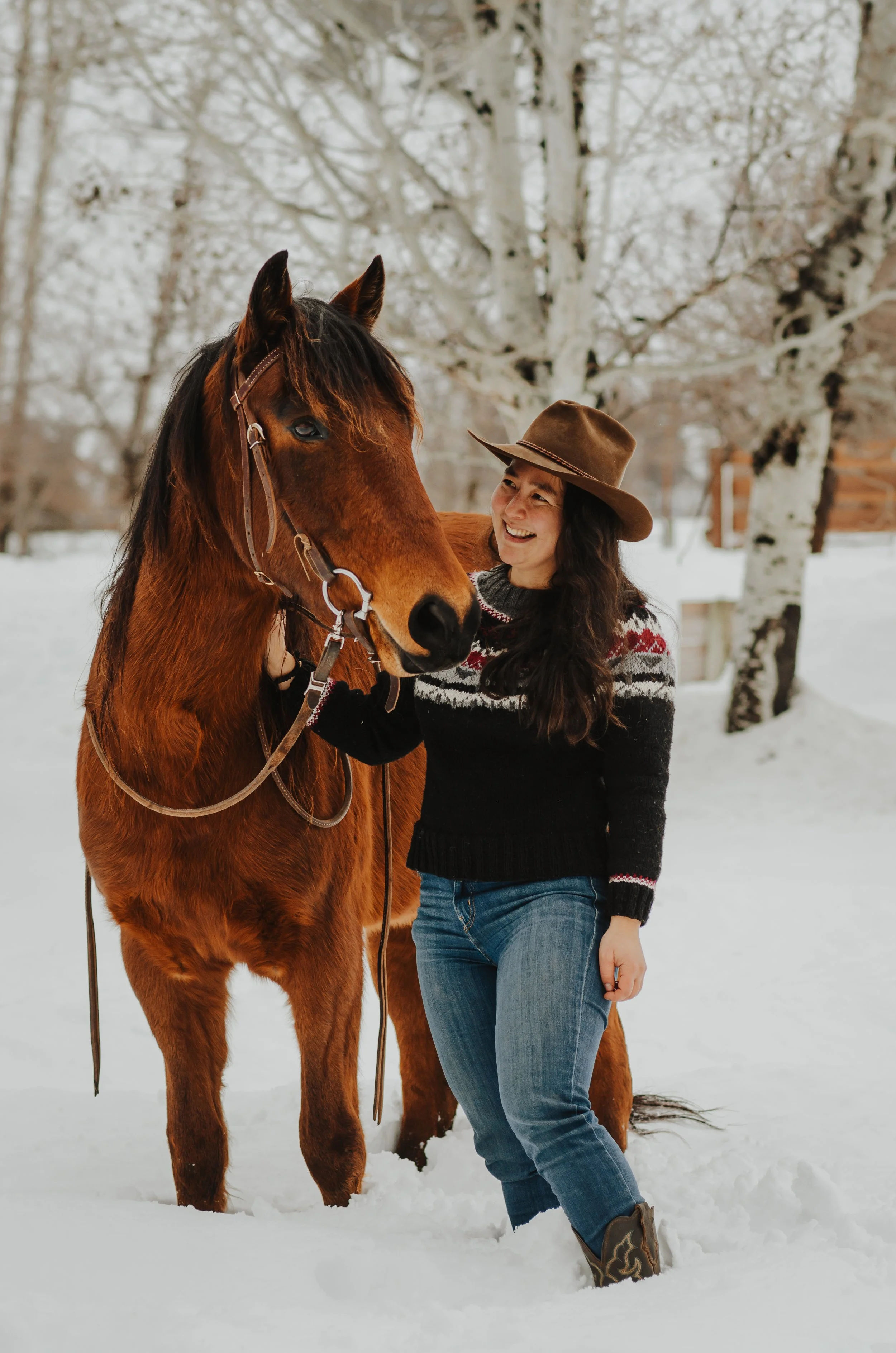 Katherine Un with her horse in the snow