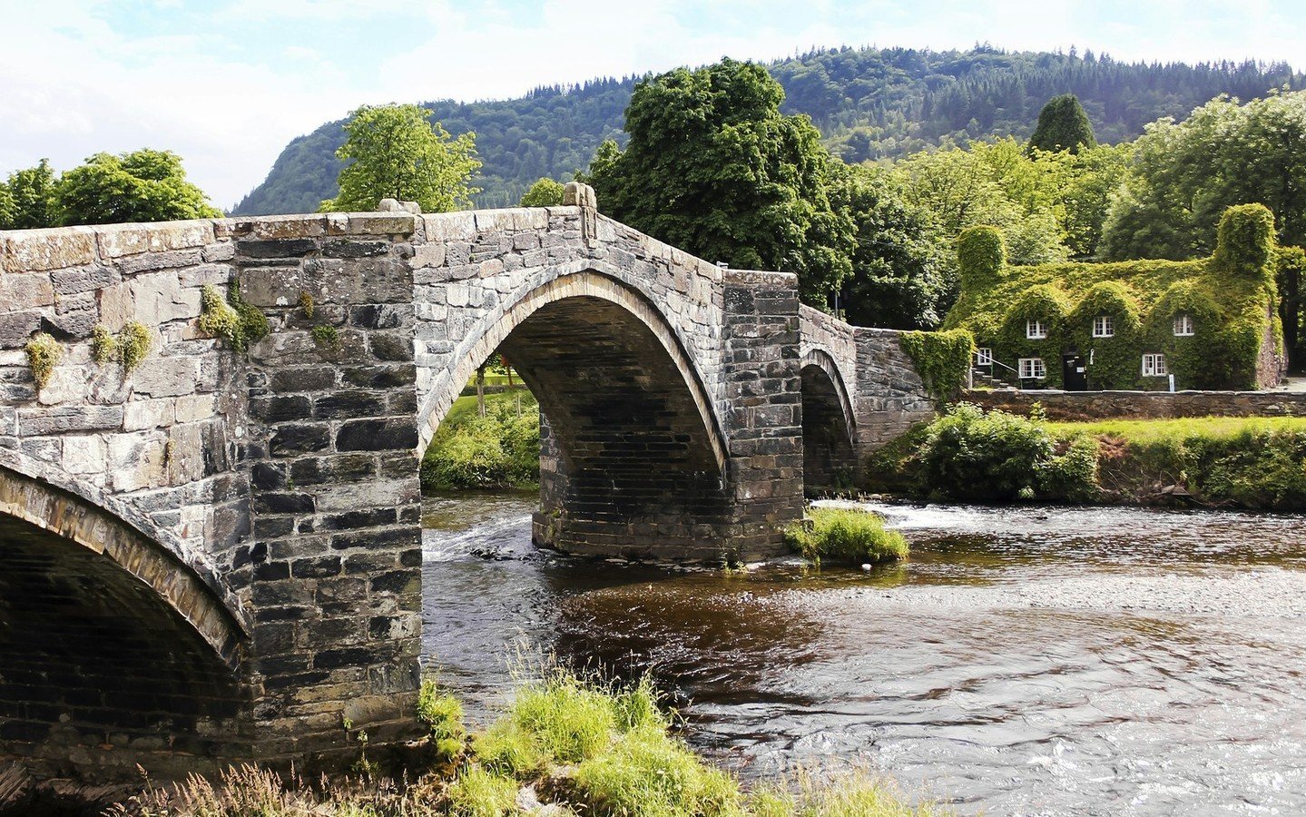 At Tu Hwnt I'r Bony (&quot;beyond the bridge&quot; in Welsh) tea rooms in Llanrwst, Wales, your cup of tea will become an enchanting cup of tea! With its rich history, this charming tearoom (on the right in the photo) offers delicious snacks and a lu