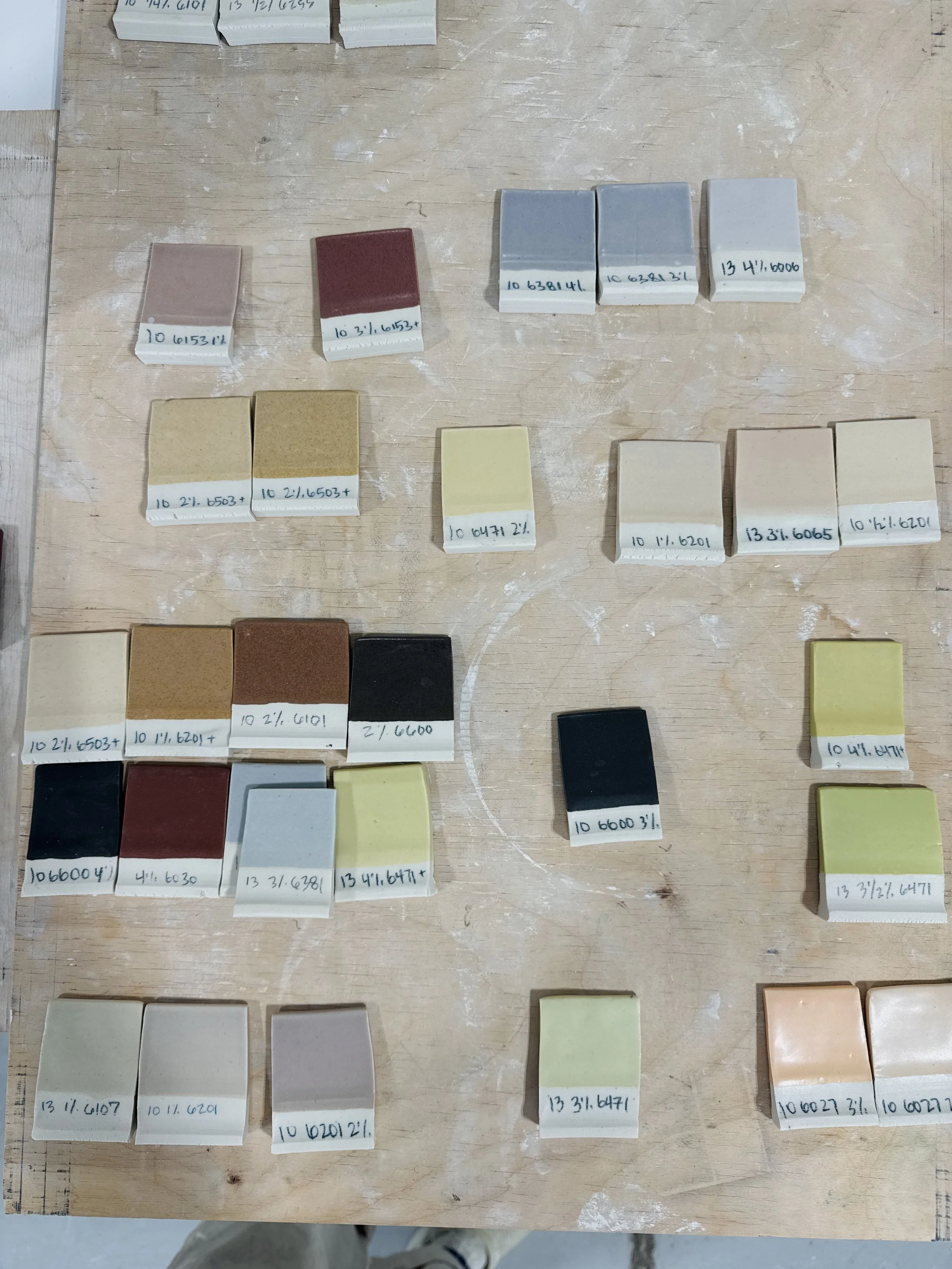 Glaze test tiles pulled from the palette board for the restaurant color palette.