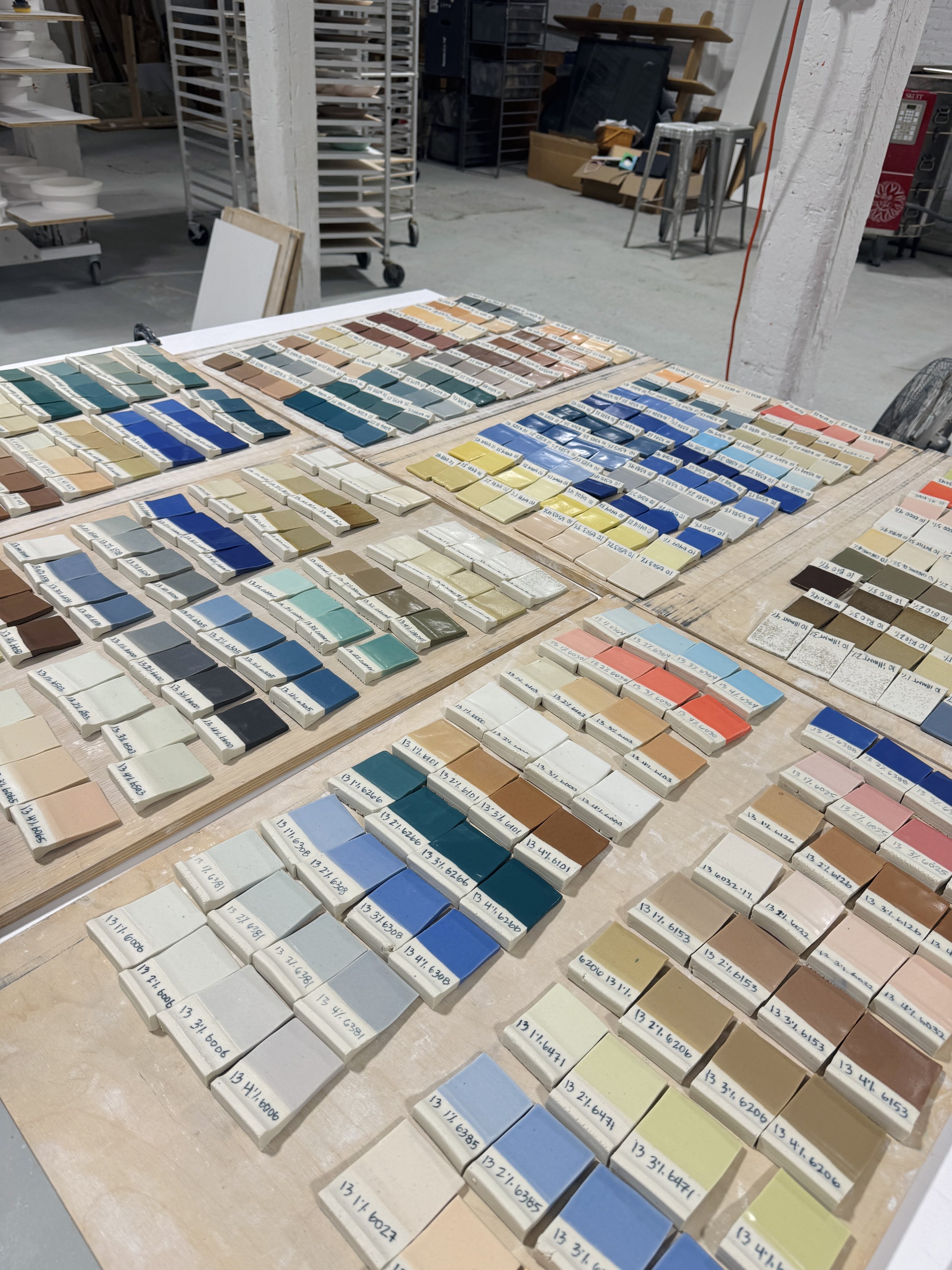 The Myrth palette board, several hundred fired porcelain glaze tiles arranged by stain and percentage.