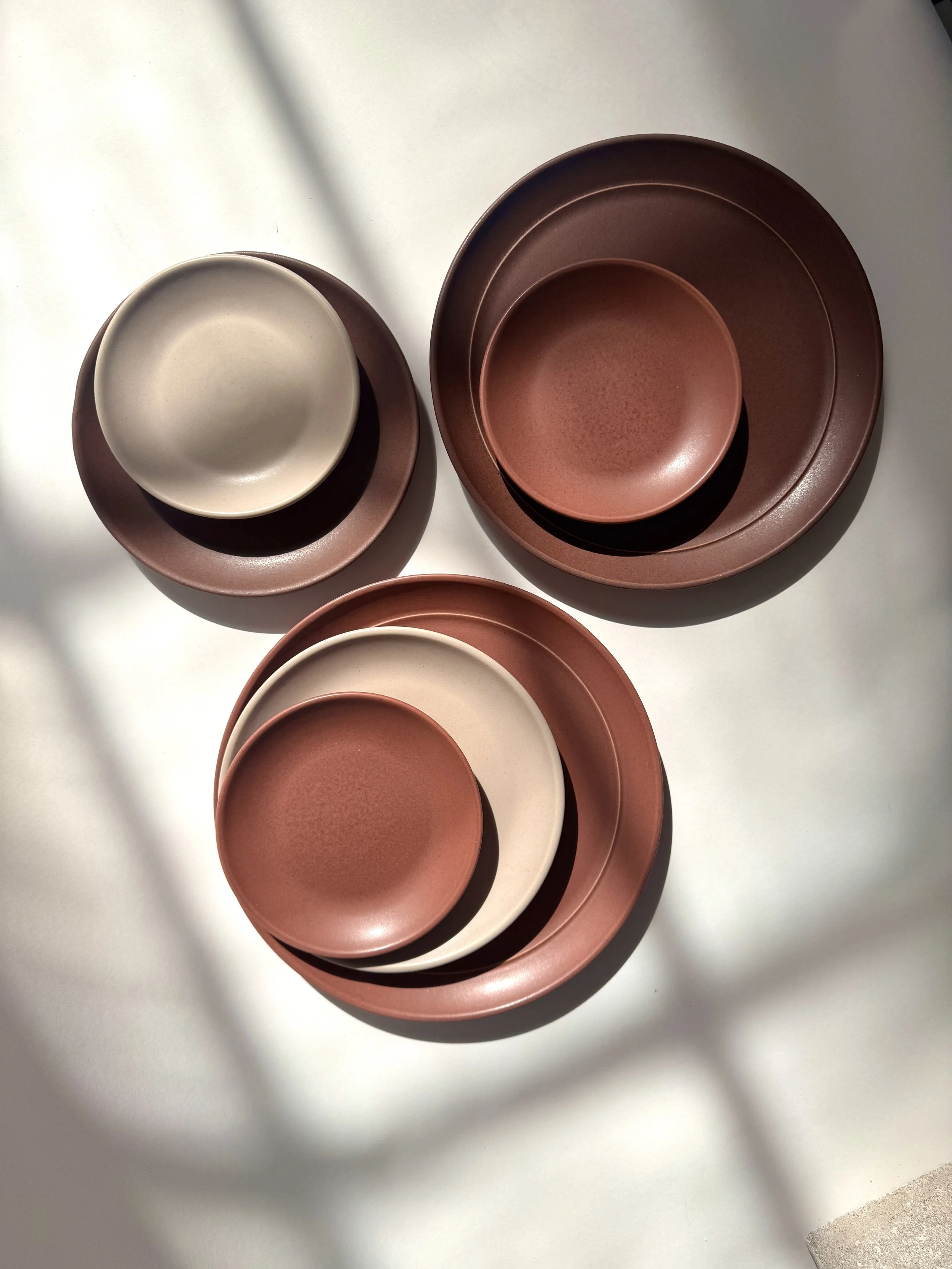 Brandywine, Rosewood, and Dove tableware arranged together.