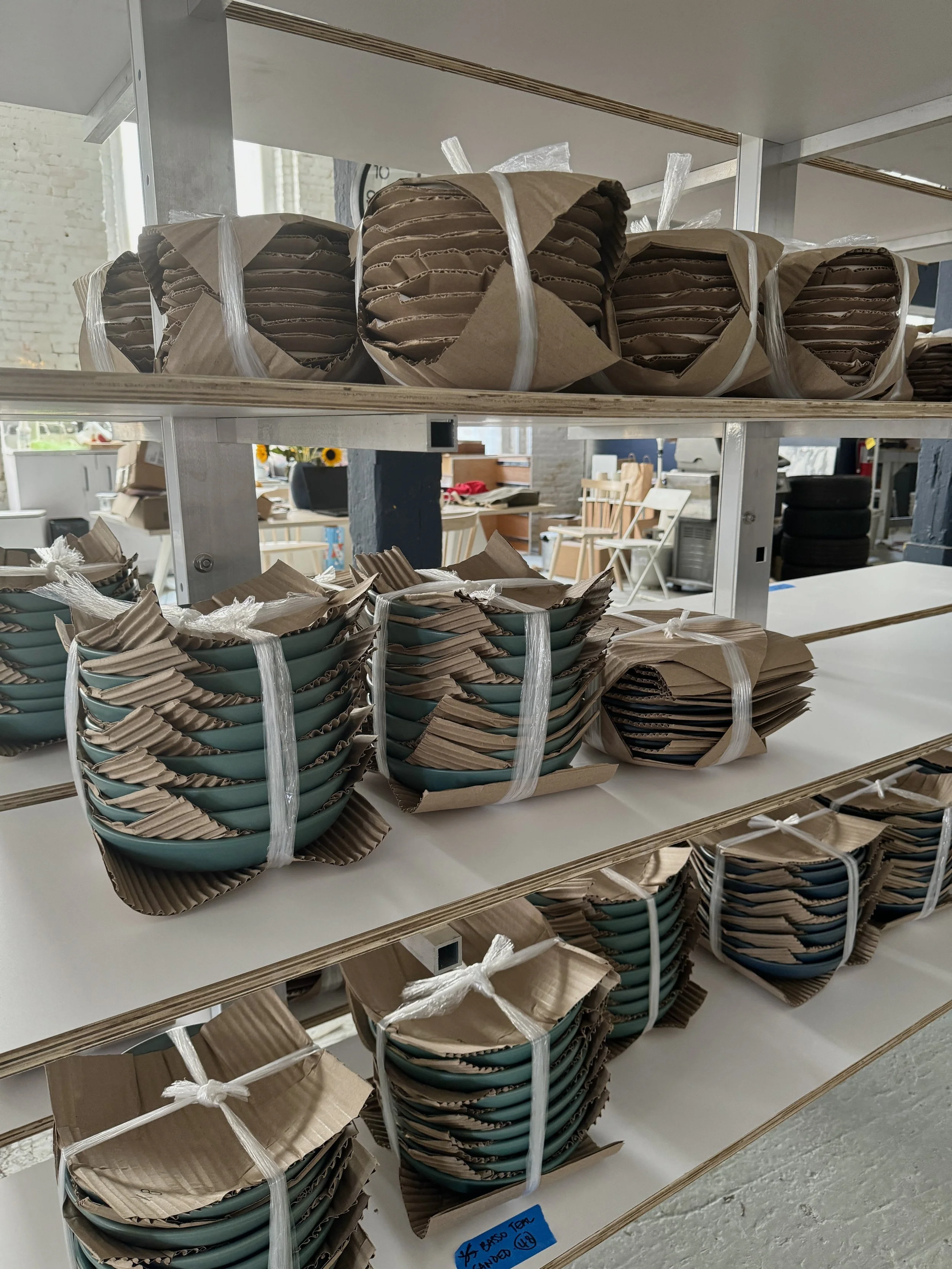 Restaurant tableware being prepared for shipping at Myrth Ceramics