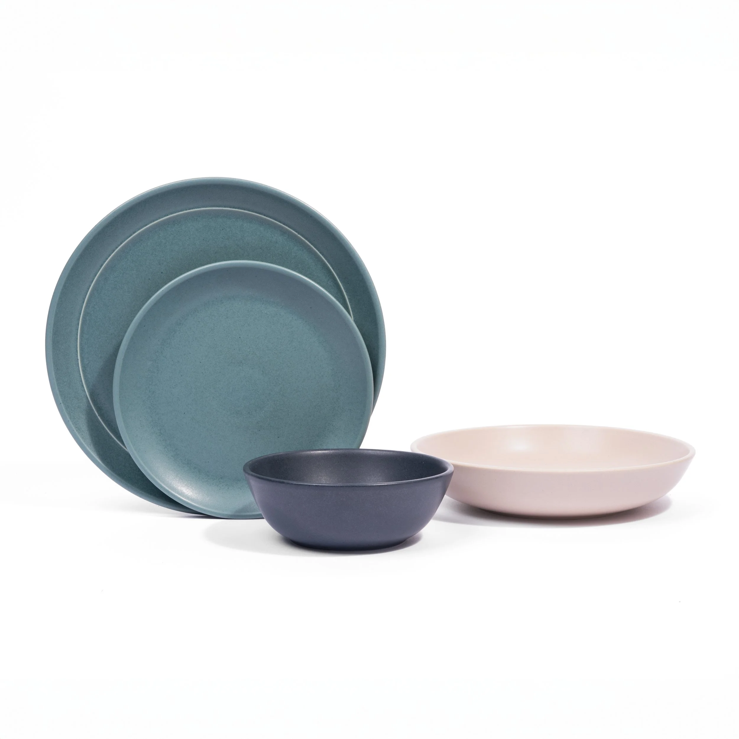 Myrth place setting mixing glazes by form, Nightfall dinner and appetizer plates with a Dove tasting bowl.