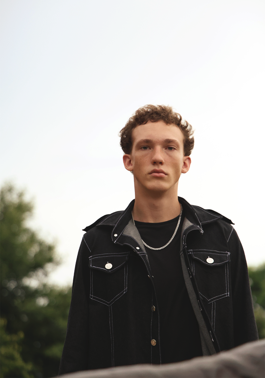 Portrait photography of boy wearing VRTY trench coat