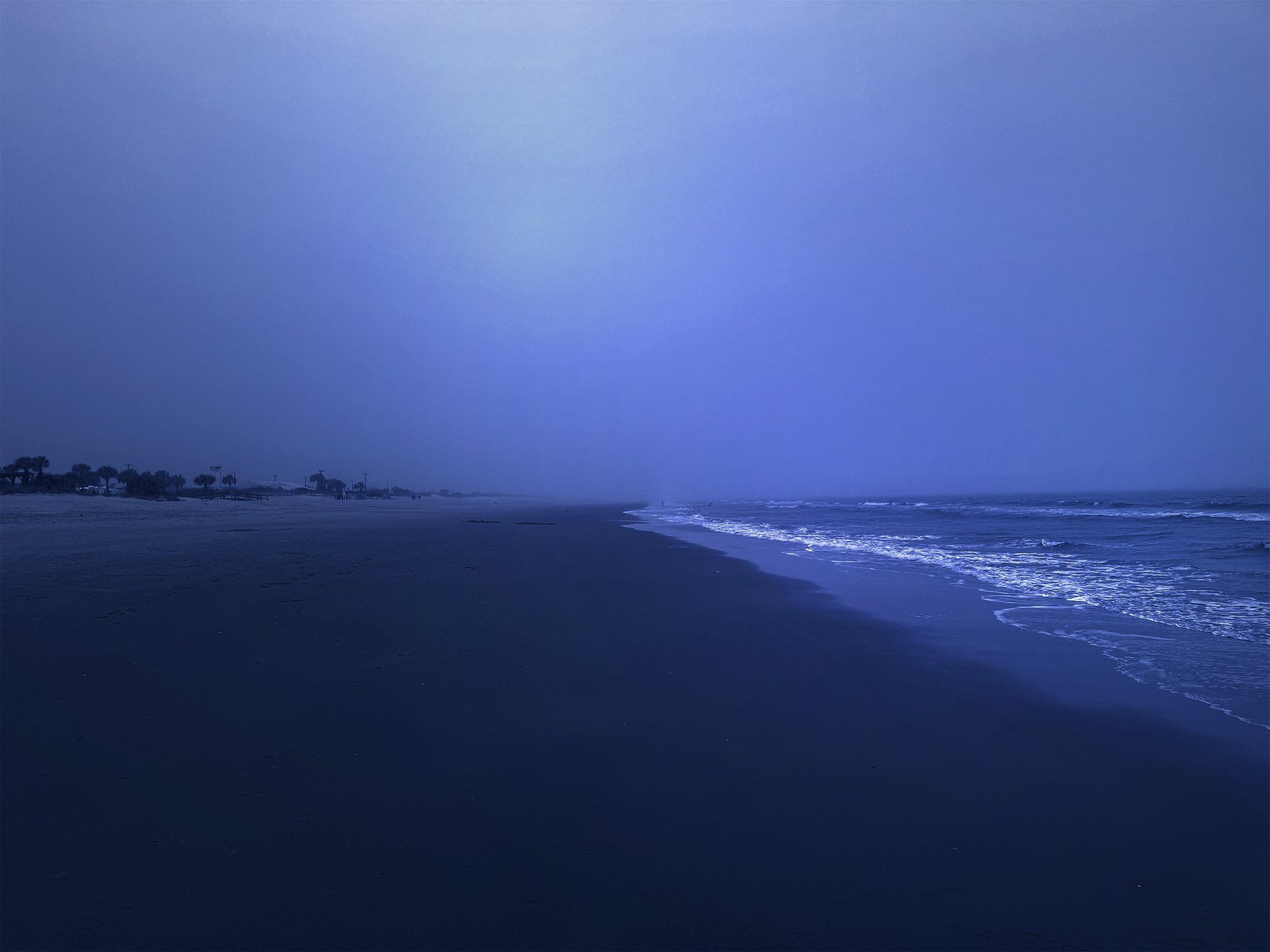 An eerily quiet beach during blue hour