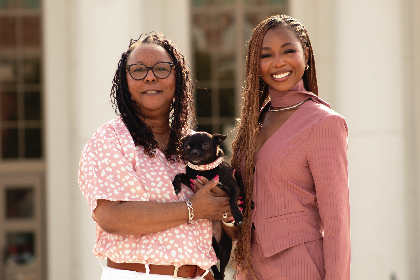 Courtney McClain smiling with mother and dog