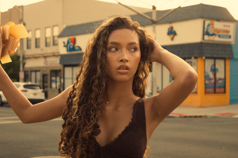 Model posing in street intersection during golden hour