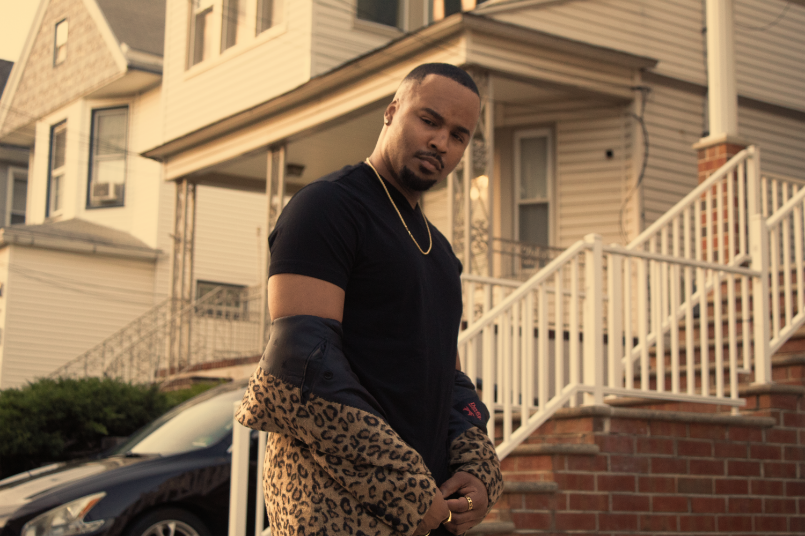 Man posing in front of townhouse