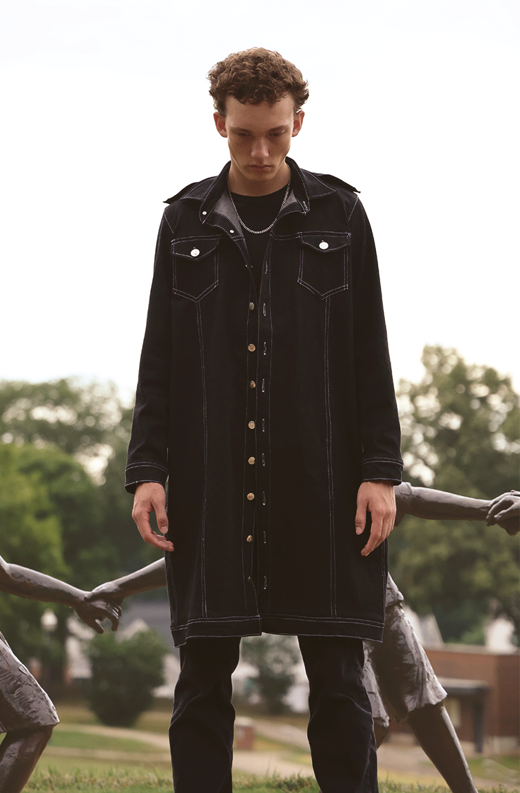 Close up shot of boy wearing VRTY trench coat in the park