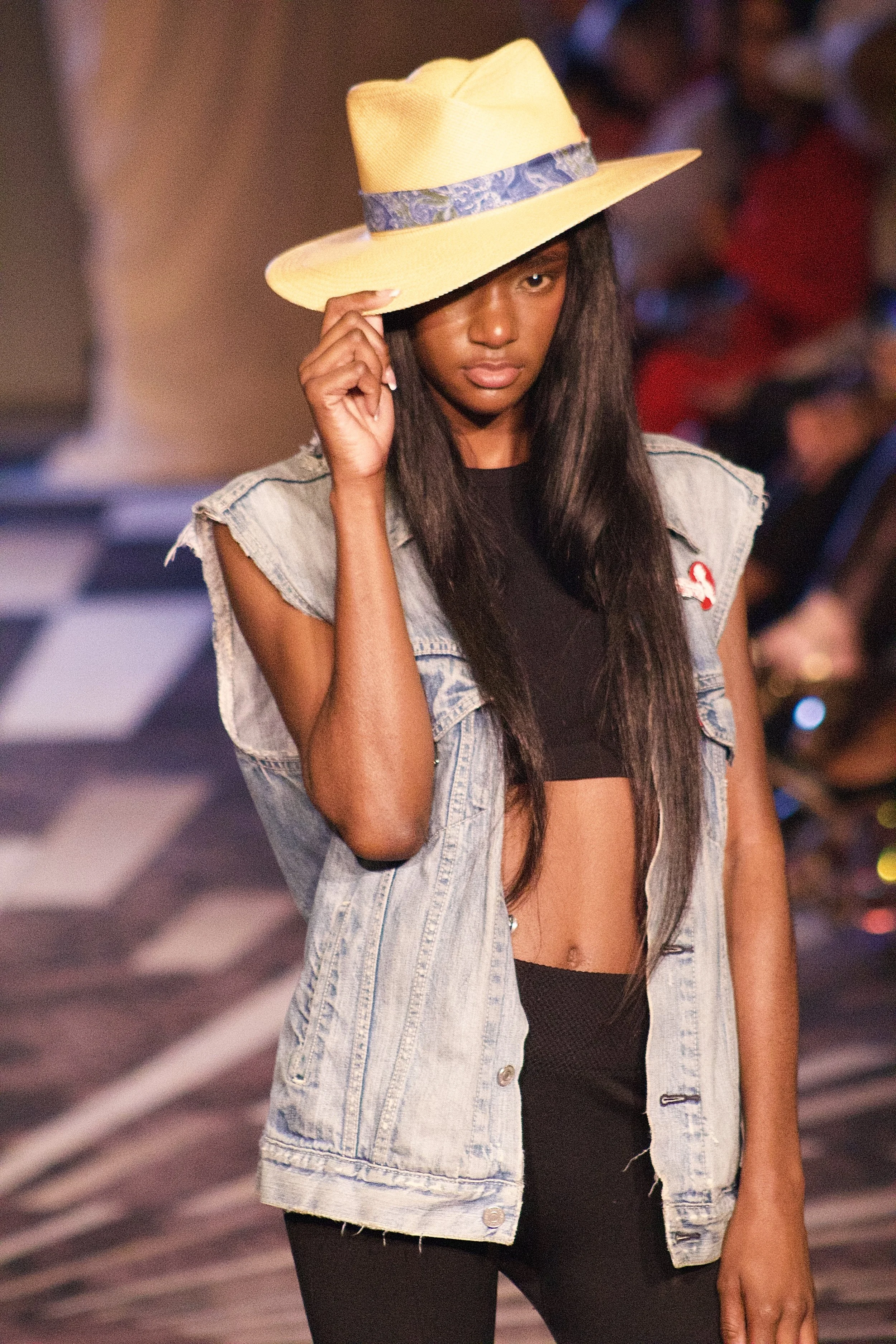 Model posing with hat on runway