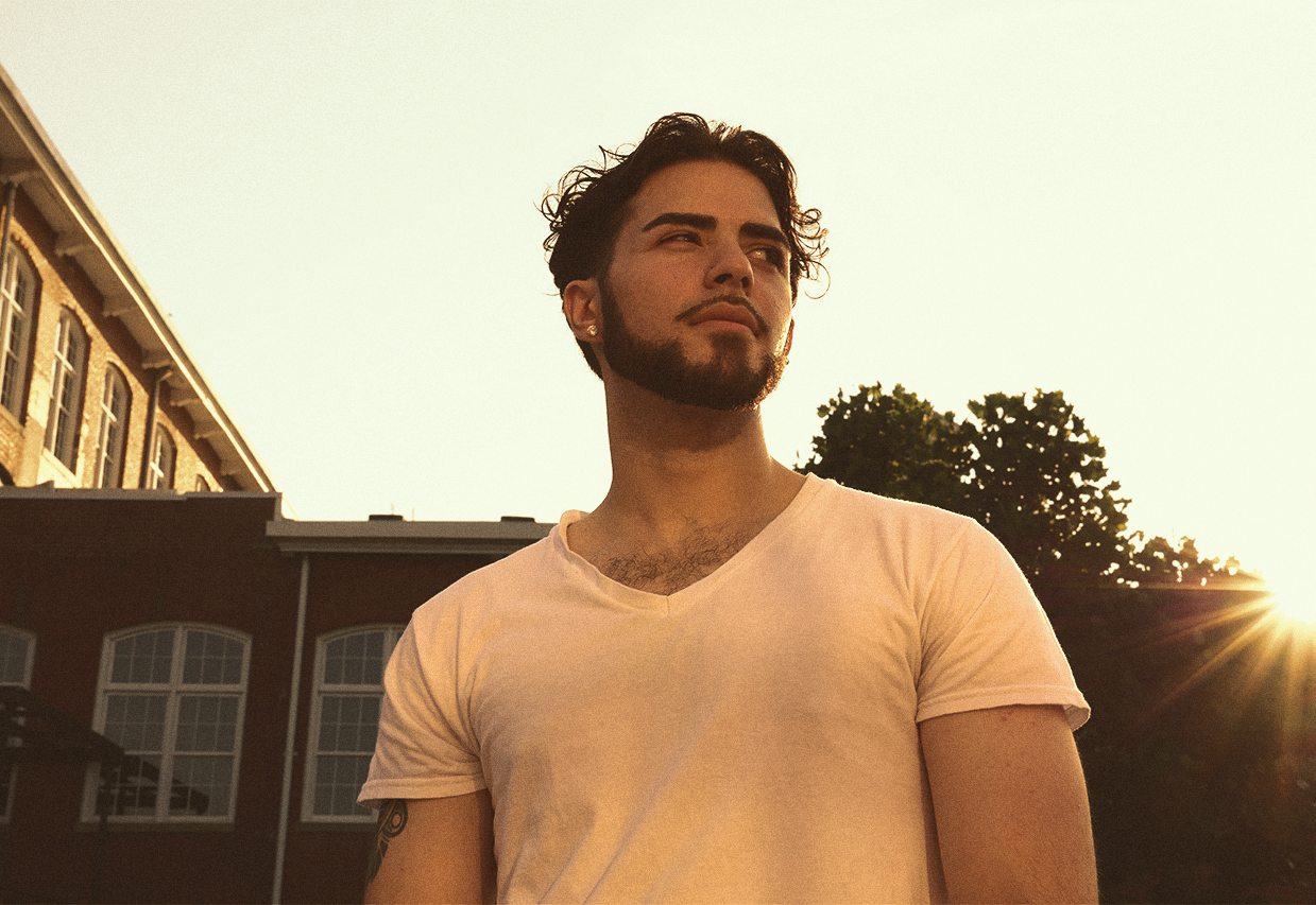 Young man defiantly looking over his shoulder during golden hour lighting