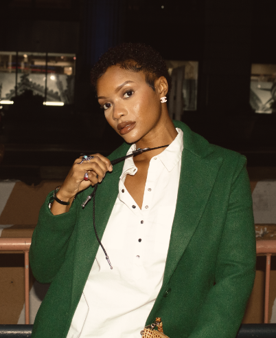 Model wearing green blazer posing