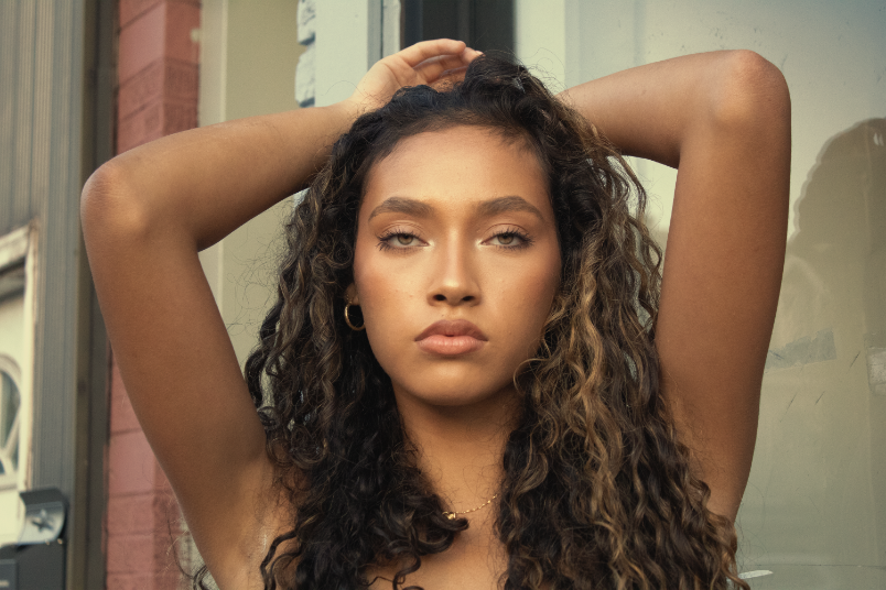 Model standing in pose with golden hour lighting