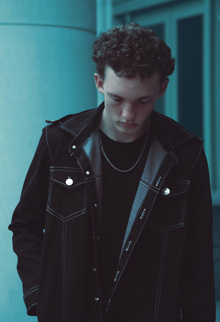 Blue hour shot of boy wearing trench coat