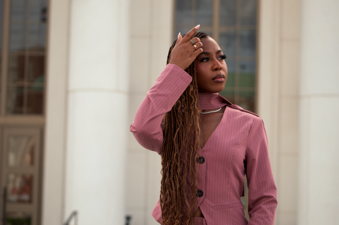 Courtney McClain adjusting hair while standing in front of Courthouse