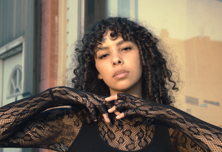 Model with curly hair posing