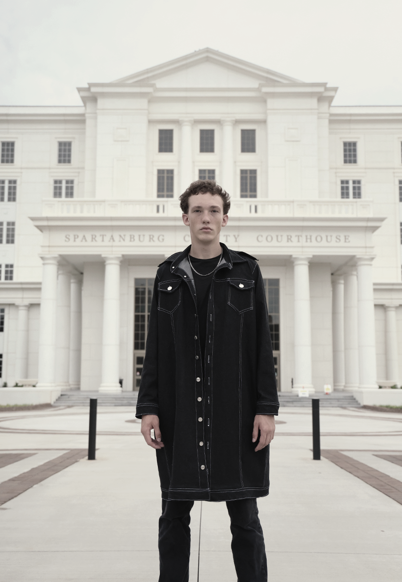 Lookbook shot of VRTY clothing worn by young man in front of government building