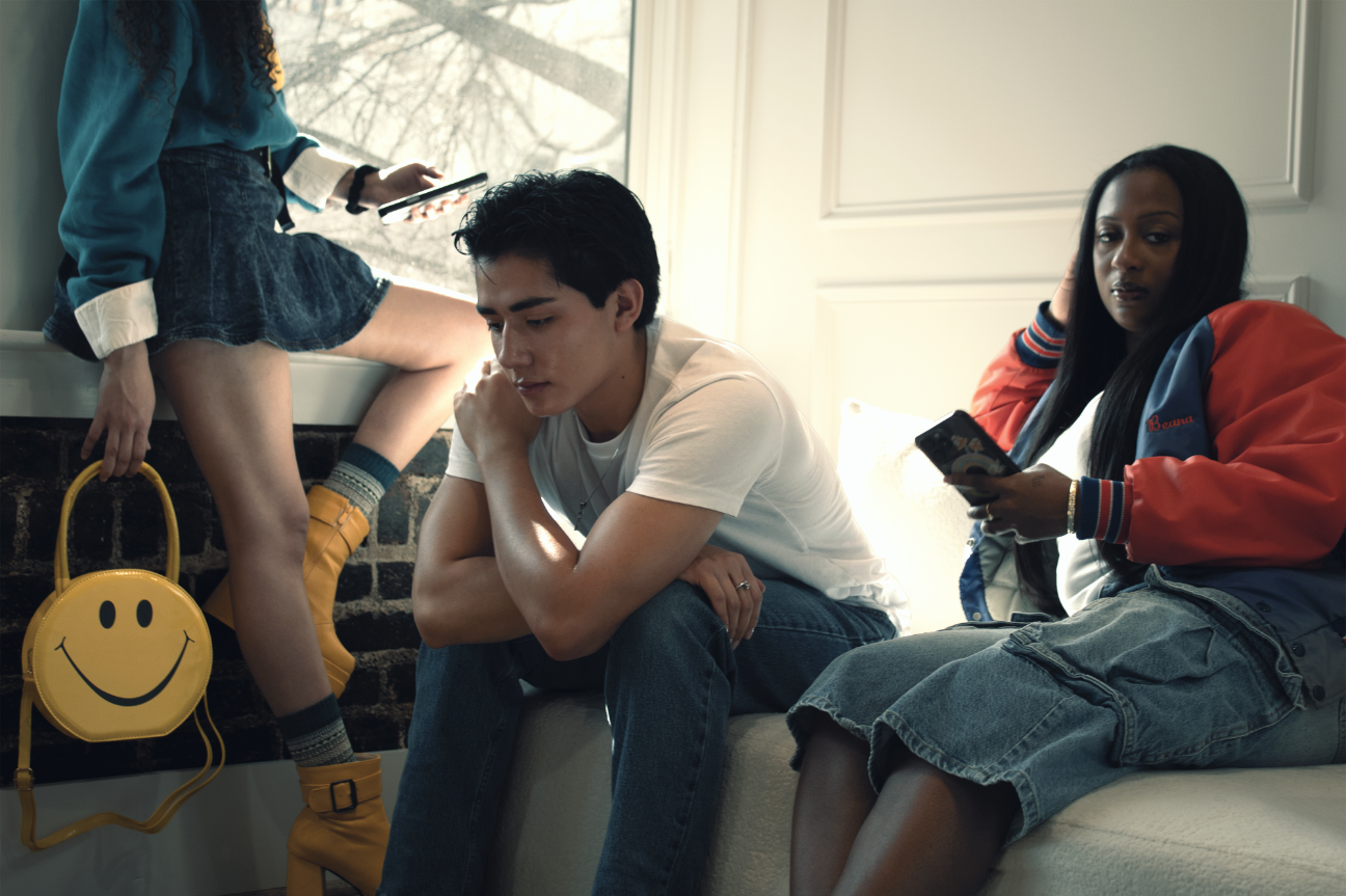 model sitting deep in thought amidst artificial happiness, symbolizing the lifestyle of the arthouse creative