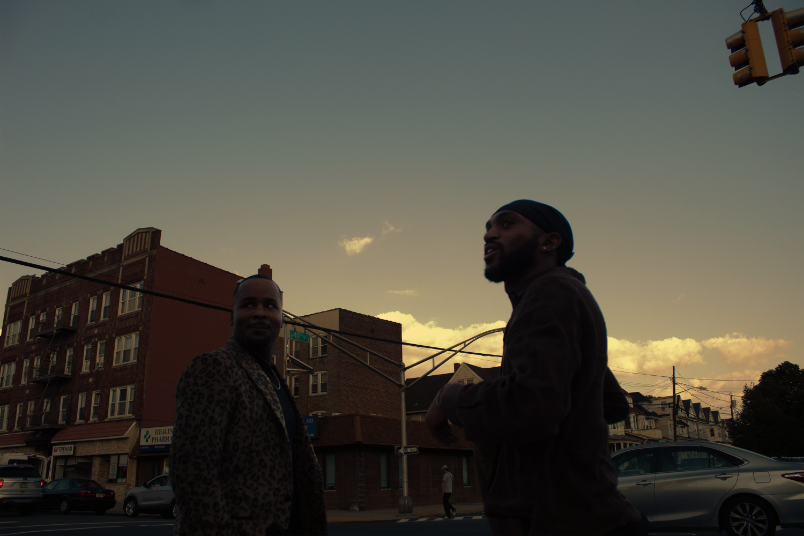 Candid photo of two men staring at sky