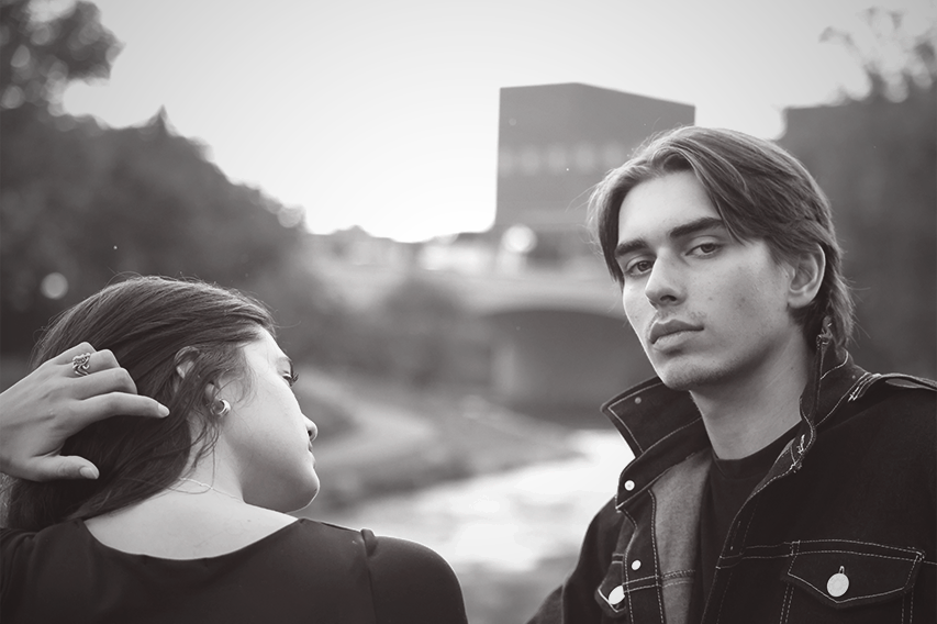 Young couple staring at camera in the park