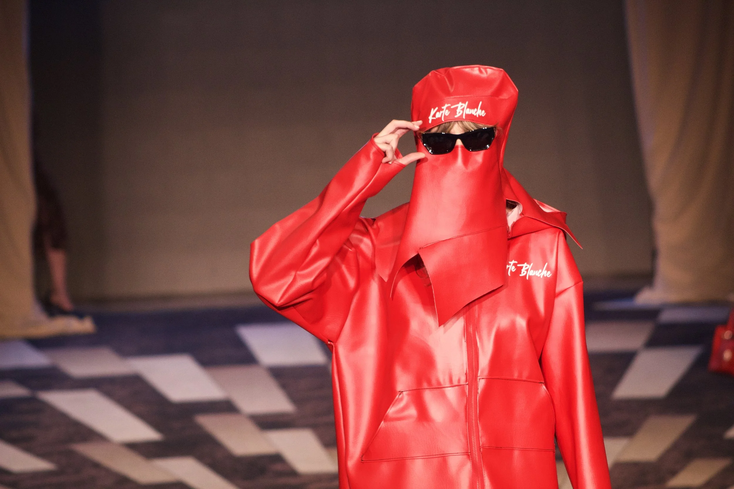 Model posing wearing full body leather outfit