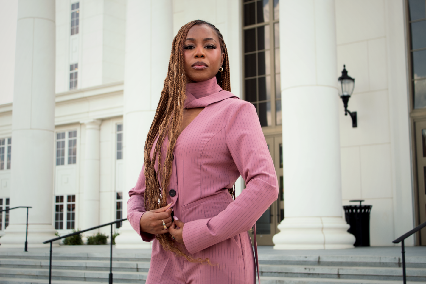 Courtney McClain posing in pink blazer
