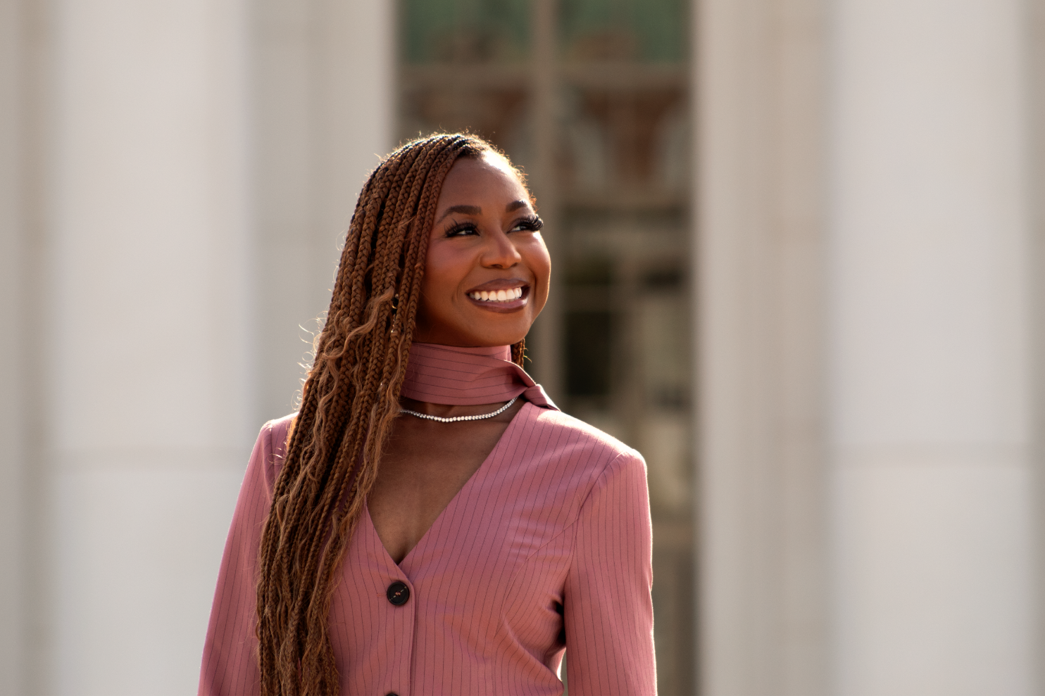 Courtney McClain smiling up in distance