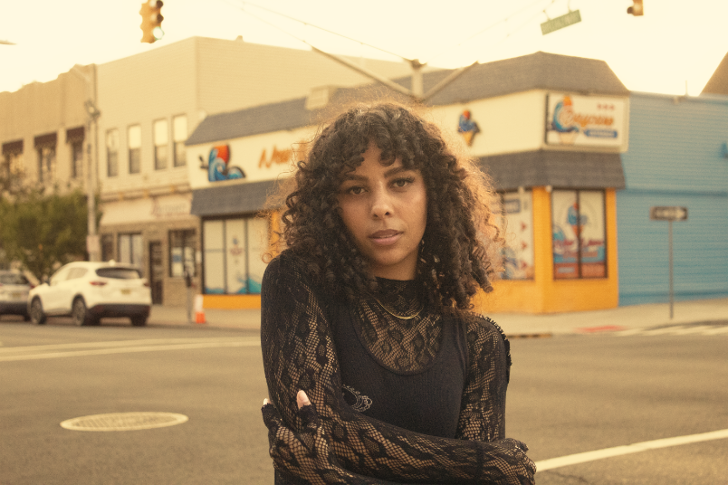 Girl posing at corner during golden hour
