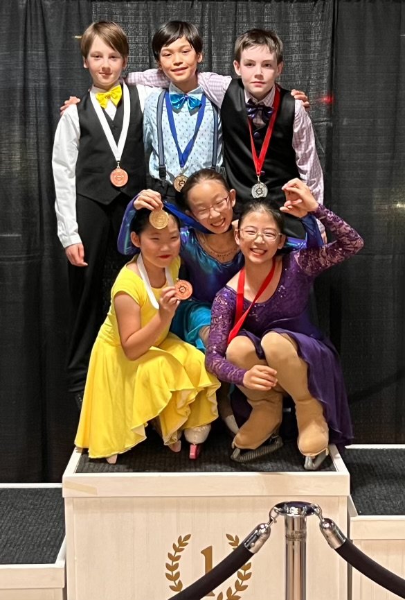 RCV skaters show off their medals from their podium sweep in the dance competition
