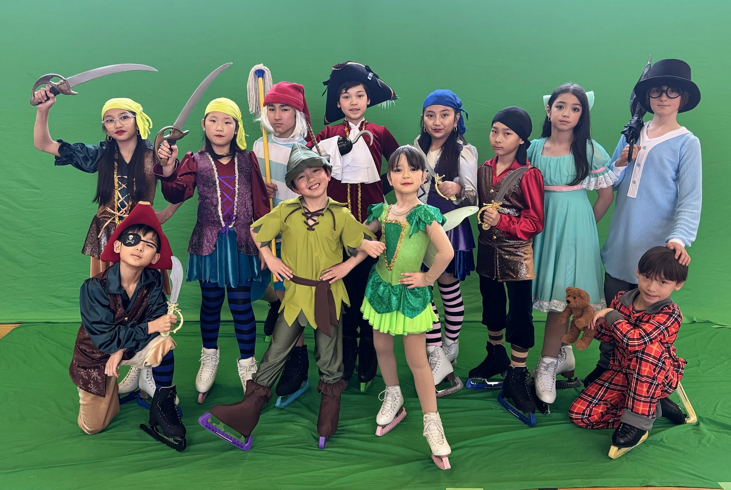 Skaters pose for a photo shoot in full costume for the Peter Pan On Ice Ice Show