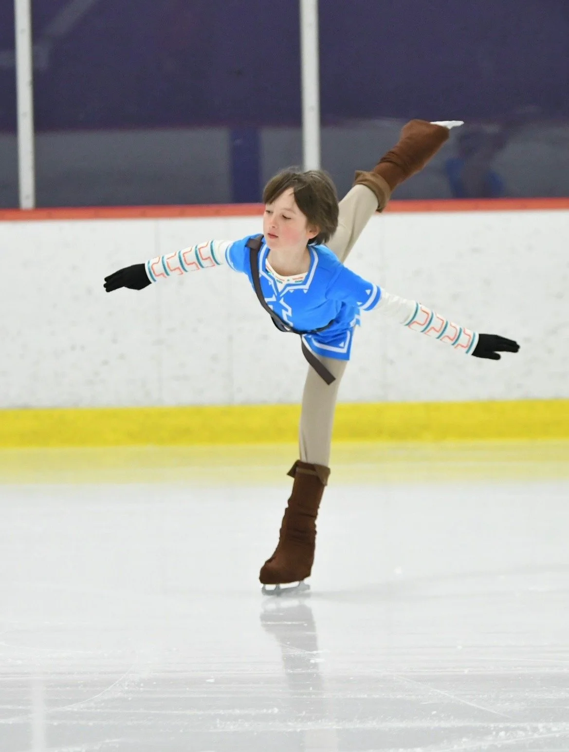 An RCV skater performs a spiral while skating to the music of Zelda