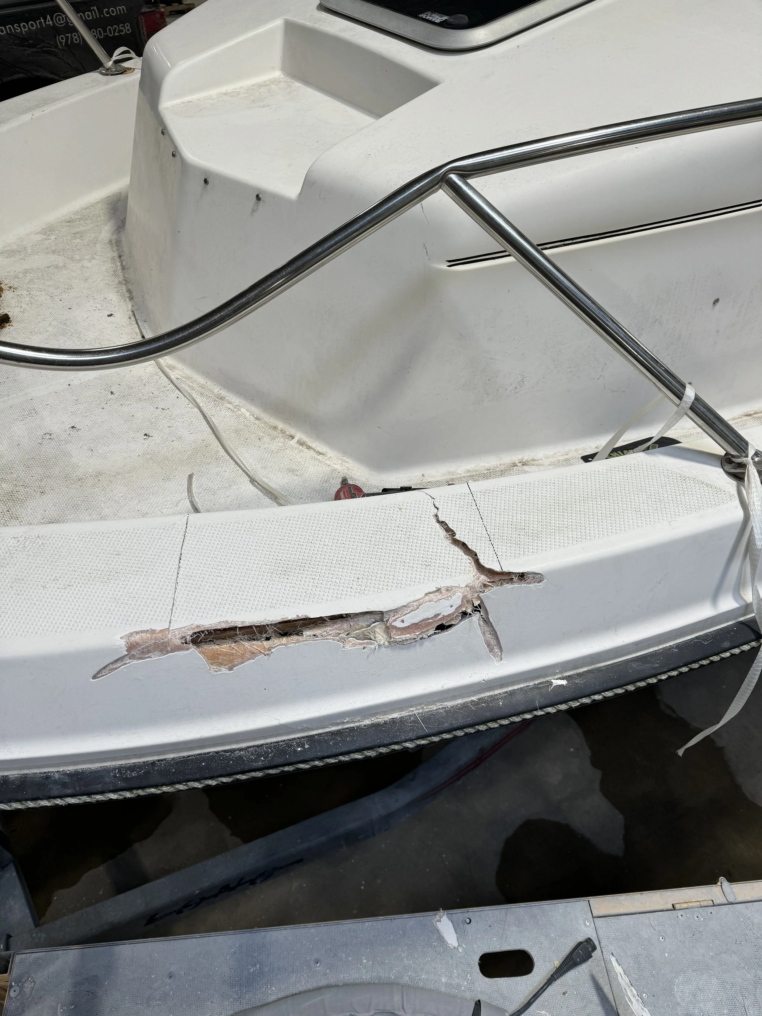 Upper side boat repair: fiberglass damage from a fallen tree removed, new fiberglass applied, non-skid surface replaced, gelcoat sprayed, and finishing done