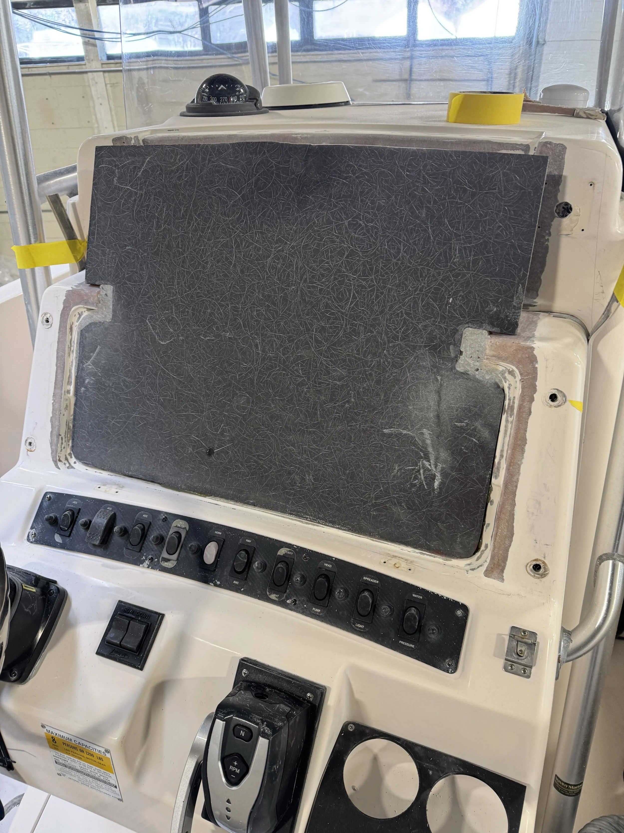 Center console modification: console cut for larger electronic display, Coosa board added, fiberglass applied, gelcoat sprayed, and polished